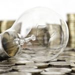 filament bulb lying on euro coins