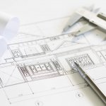 Construction plans and drawing tools on blueprints